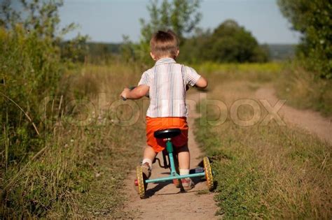 Little Boy Rides A Tricycle Stock Photo Colourbox Tricycle Short