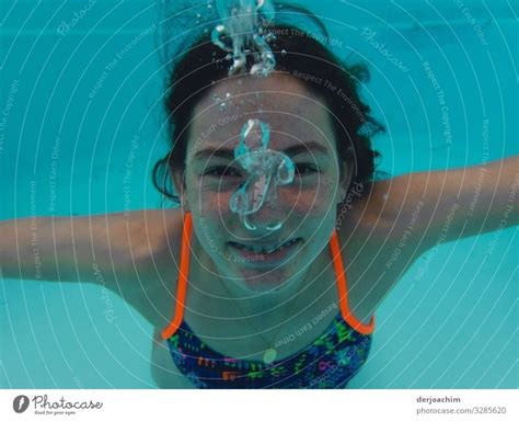 A Girl Under Water Looks At The Photographer She Laughs And It Goes Blub Blub A Royalty