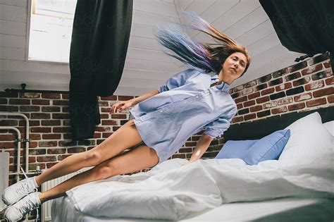 Female Jumping On Bed By Stocksy Contributor Andrey Pavlov Stocksy