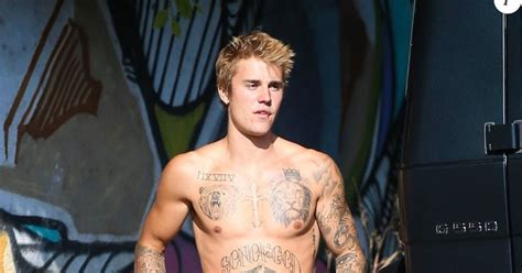 justin bieber half naked he proudly displays his muscular and tattooed chest artist topicality
