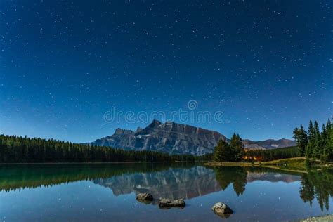 Full Of Stars Above The Mount Rundle From Two Jack Lake At Night In