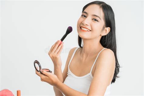 Beautiful Young Woman Applying Foundation Powder Or Blush With Makeup Brush Mixed Race Asian