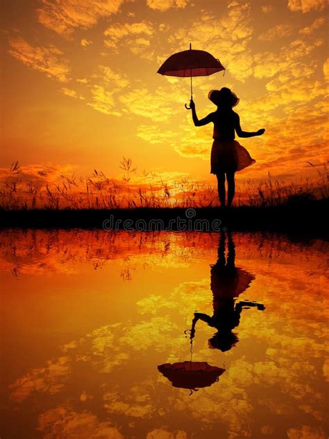 Umbrella Woman And Sunset Silhouettewater Reflection Stock Photo