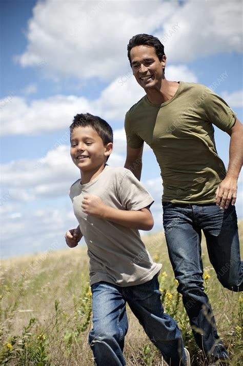 Father And Son Running Through A Field Stock Image F0036727