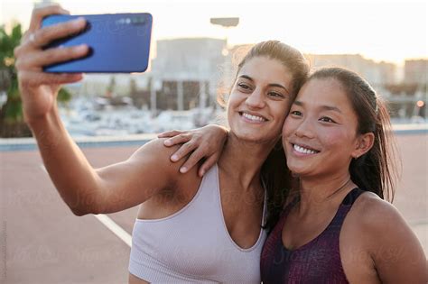Sporty Friends Taking Selfies Together By Stocksy Contributor Ivan Gener Stocksy