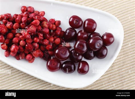 Cherries And Cherry Stones Pits On A Plate Stock Photo Alamy