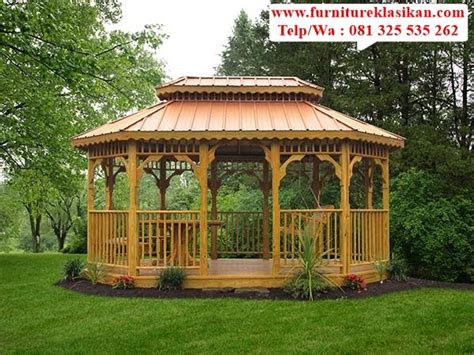 A Wooden Gazebo Sitting In The Middle Of A Lush Green Field Next To Trees