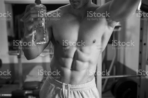 Attractive Muscular Man Drinking Water In Gym Stock Photo Download