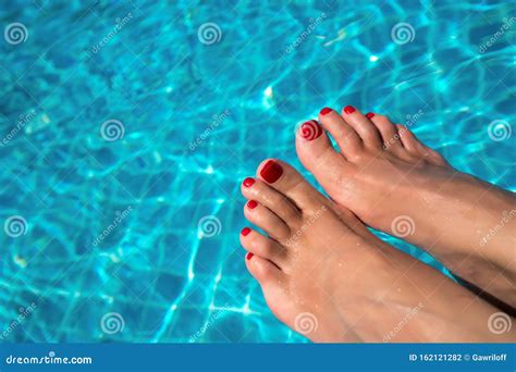 Beautiful Women Legs In Blue Water Beautiful Female Feet Relaxing By The Swimming Pool Summer
