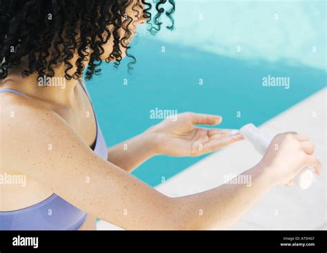 Woman Applying Sunscreen Stock Photo Alamy