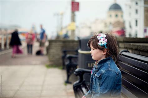 Girl Sitting On A Bench On The Seafront By Stocksy Contributor Christina K Stocksy