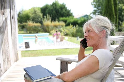 Senior Woman Relaxing Outside By The Pool Stock Image Image Of