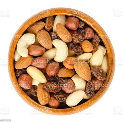 Nuts And Raisins In Wooden Bowl Over White Stock Photo - Download Image