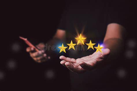 Hand Holding The Stars To Five Stars Giving A Five Star Rating Stock