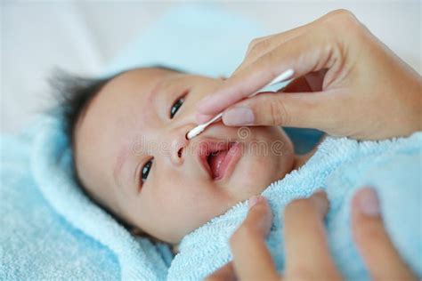 Mother Use Cotton Swab Moistened With Alcohol To Wipe Clean The Navel