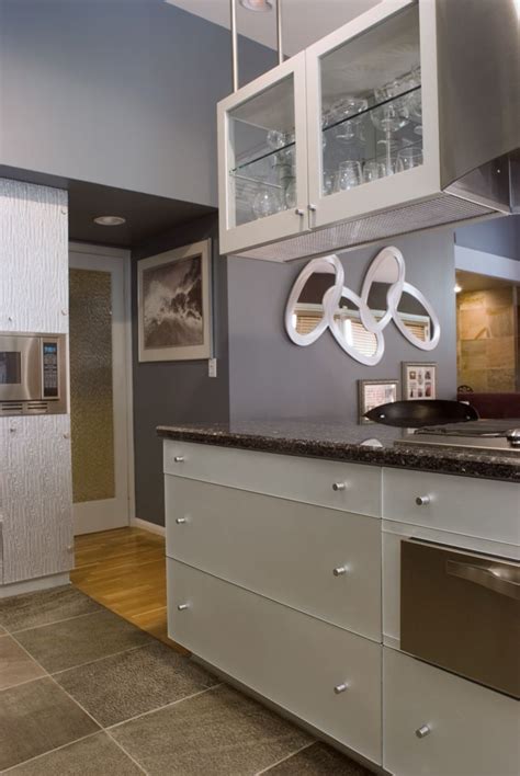 Keep them organized by hanging them on the cabinet walls. Contemporary styled kitchen. Hanging cabinet. Stainless ...