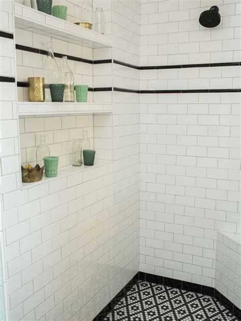 A Black And White Tiled Bathroom With Shelves