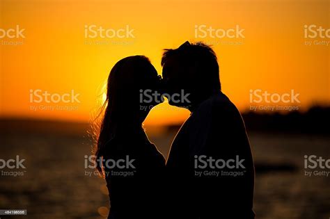 Young Couple Kissing On The Beach Sunset Stock Photo Download Image