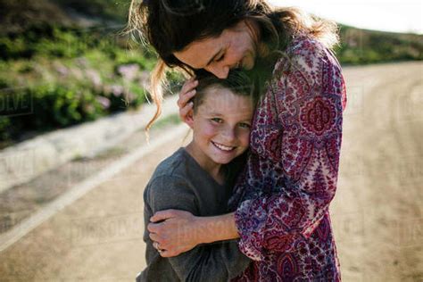 Mom And Son Hugging While Son Smiles In Southern California Stock