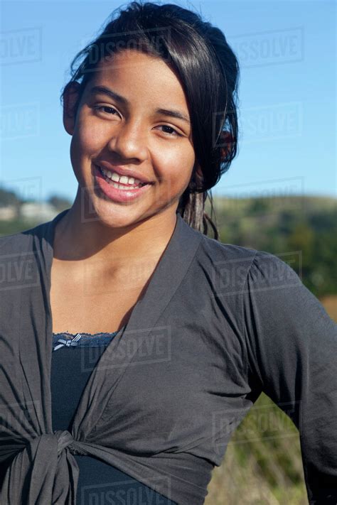 Hispanic Teenage Girl Smiling Outdoors Stock Photo