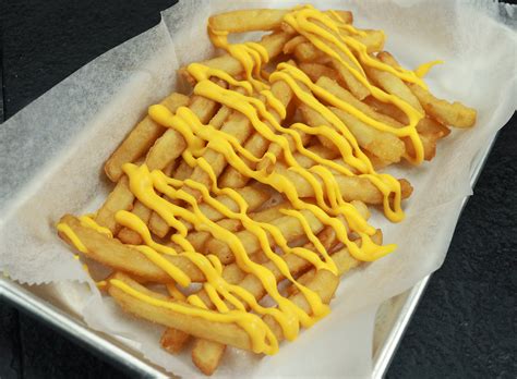 The sides include french fries with hot cheddar cheese sauce; Cheese Fries | Los Fernandez Taqueria