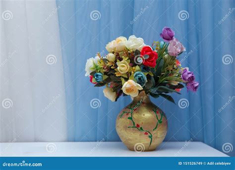 Vase With Beautiful Aster Flower Bouquet On Table Against Blue