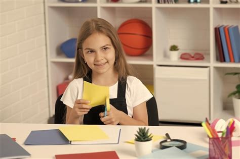 Premium Photo Happy Child Cut Out Paper In School Classroom