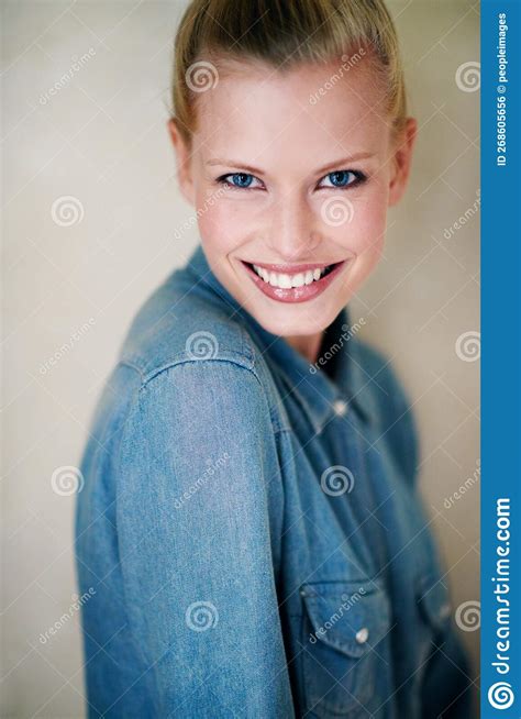 Purely Natural Portrait Of An Attractive Young Woman Standing Against