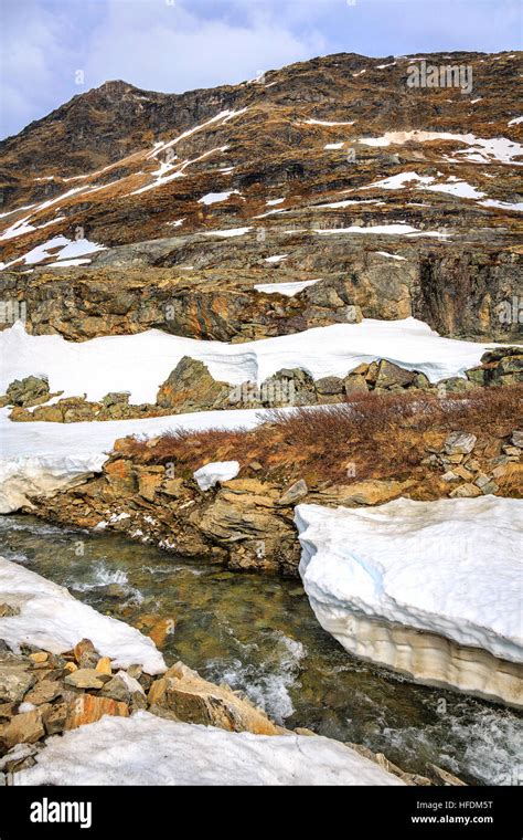 Thawing Snow Revealing The Rocky Landscape At Jotunheimen National Park