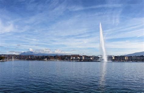 Lake Geneva Switzerland With Water Fountain And Blue Sky With Cl