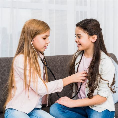 Free Photo Two Cute Girls Play Doctor And Hospital Using Stethoscope