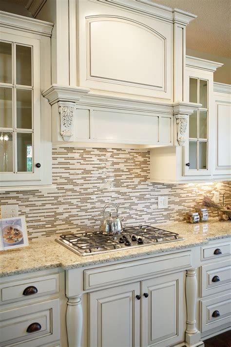 Cream colored kitchen cabinets with white appliances. White counters with granite an tile backsplash | Cream ...