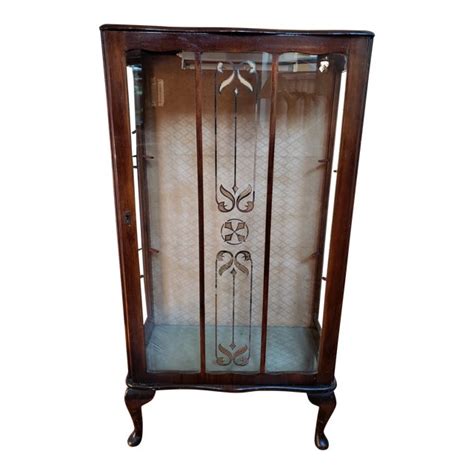 Designed to proudly put some of your favorite items on display. 1930s Traditional Wooden Curio Cabinet | Chairish