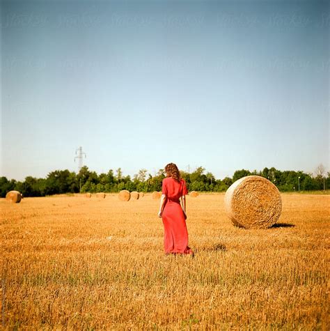 Anonymous Lady In Red In A Field Of Grain Del Colaborador De Stocksy