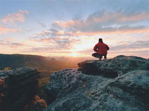 Hiker Standing On Top Of A Mountain And Enjoying Sunrise Beautiful