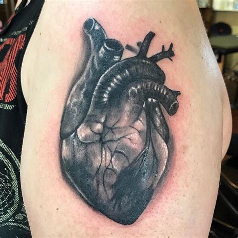 A tattoo of a heartbeat that starts with a heart, has a heart at the center, and ends with a name tattoo. 110+ Best Anatomical Heart Tattoo Designs & Meanings - (2019)