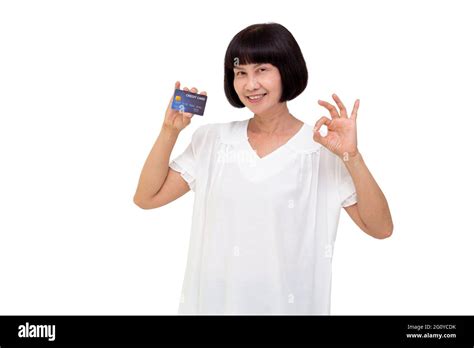 mature asian woman showing debit or credit card senior and retired aged holding insurance card
