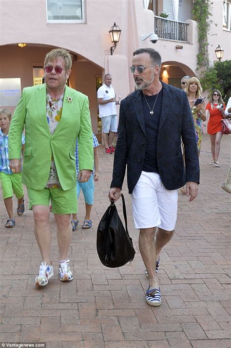 In his interview with parade magazine, elton john recalled his first meeting with his partner, david furnish. Elton John makes in garish green suit with husband David ...