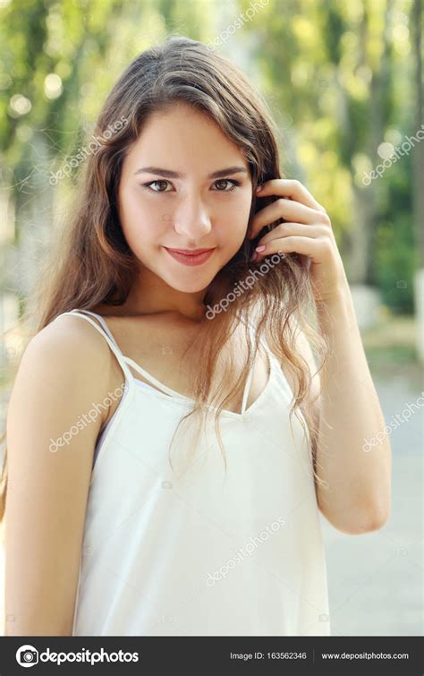 Portrait Of Beautiful Young Woman In Park — Stock Photo © 5seconds