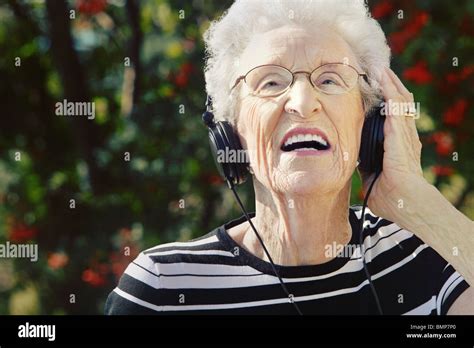 Sherwood Park Alberta Canada A Senior Woman Wearing Headphones Stock