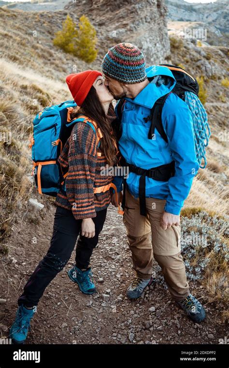 Romantic Couple Kissing While Hiking On Rock Mountain During Vacation