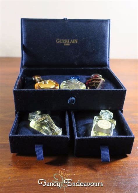 Set of make up cosmetics isolated on blue background. Guerlain Paris 5 Perfume Sample Miniature Set in Plush ...