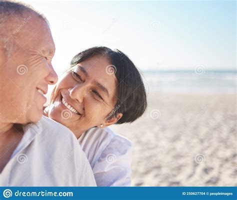 Affectionate Mature Mixed Race Couple Sharing An Intimate Moment On The Beach Senior Husband