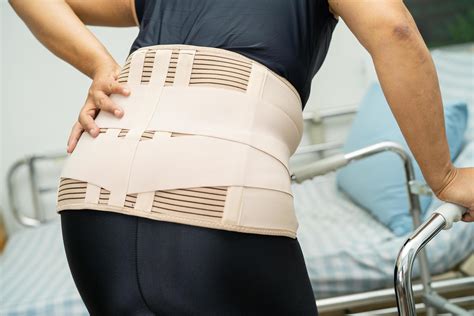 Asian Lady Patient Wearing Back Pain Support Belt For Orthopedic Lumbar