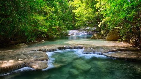 Thailand Tropical Vegetation Green River With Waterfalls And Stepped