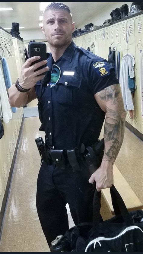 a police officer is taking a selfie in the locker room with his camera phone