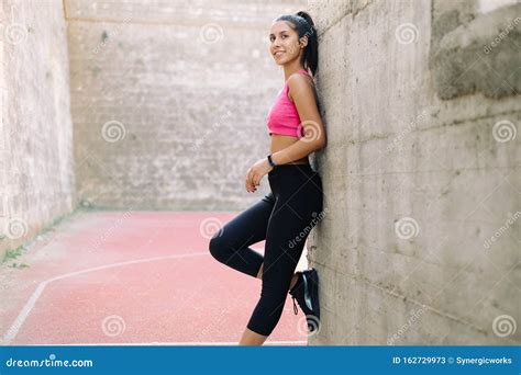 Fit Woman Leaning Against Wall With Right Foot Up Stock Image Image Of Active Health