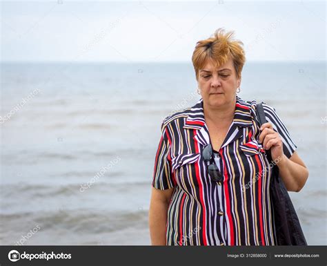 Mature Plump Woman Resting On The Beach Of The Sea Stock Photo By Ramvseb