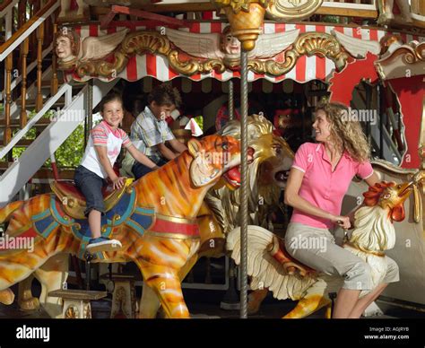 Mother And Kids On A Carousel Stock Photo Alamy