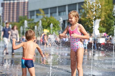Happy Children Playing In A Fountain Stock Image Image